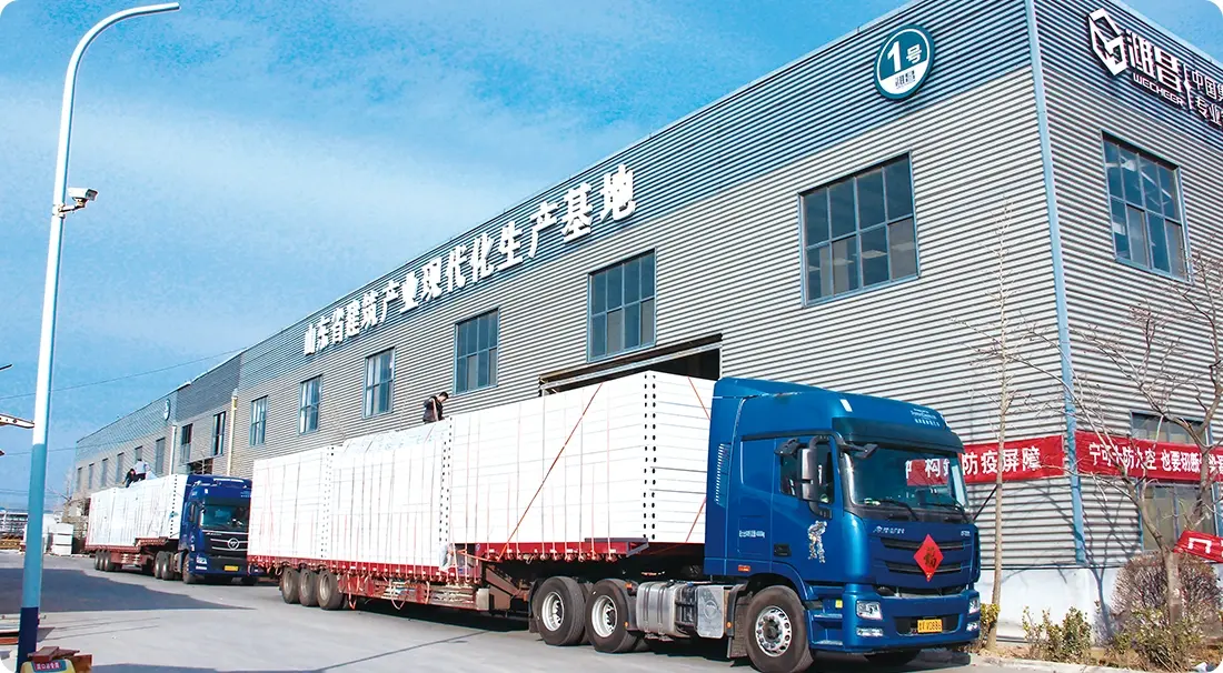 Shandong modernization production base with loaded trucks transporting prefabricated building panels for delivery